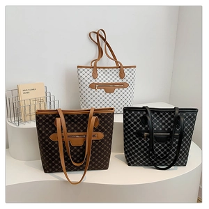 Detail of trendy geometric patterned tote bags with zipper pockets and long handles