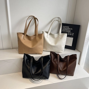 Minimalist large capacity PU leather tote bags in four colors on marble display