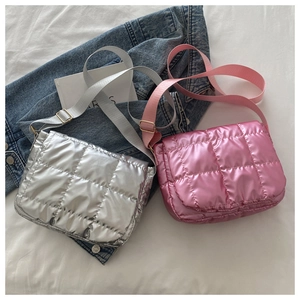 Detail of silver and pink quilted padded crossbody bags with metallic finish