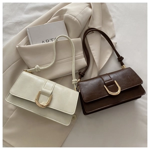 Detail of vintage oil wax leather crossbody bags with golden U-shaped metal buckles