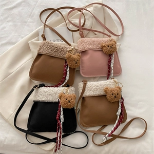 Lambswool crossbody bags with bear charms in brown, pink, black, and beige colors