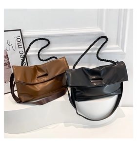 Detail of soft matte synthetic leather bags with thick rope handle and adjustable strap
