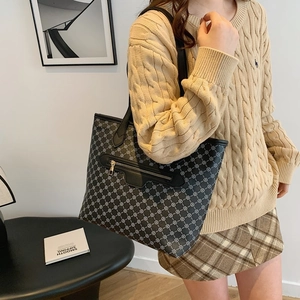 Women's black printed tote bag with clover patterns and front zipper pocket