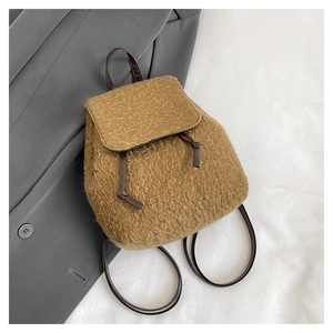 Detail of wool plush backpack featuring leather drawstring and soft lambskin texture
