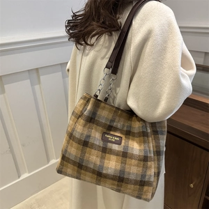 Retro plaid tote bag with brown leather straps shown on model for autumn winter commute