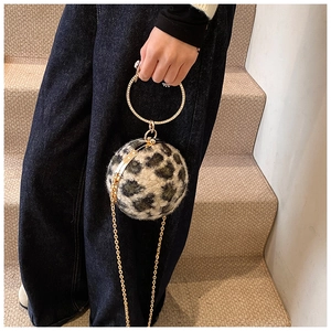 Detail of leopard print spherical handbag with sparkling crystal handle and gold chain