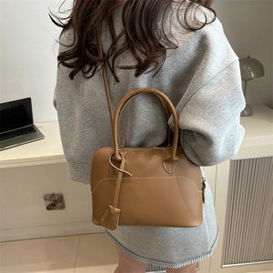 Classic brown leather bowling bag with twin handles and detachable shoulder strap