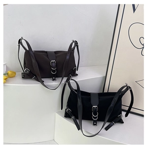 Detail of nylon baguette bags in dark coffee and black with leather buckle accents