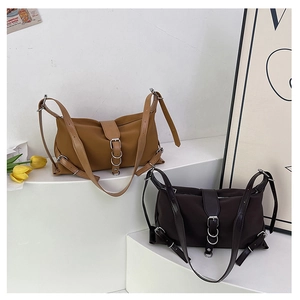 Detail of chic nylon baguette bags in khaki and dark brown with silver metal buckles