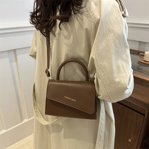 Retro dark brown leather shoulder bag with gold lettering and adjustable strap for women
