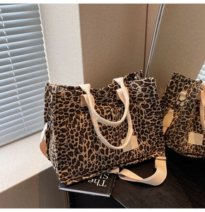 Detail view of the leopard print canvas tote bag with adjustable strap and side pocket