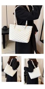 Close-up of white quilted tote bag with golden metal hardware and double shoulder straps