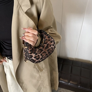 Chic leopard print half-moon bag with black leather trim and gold-tone metal accents