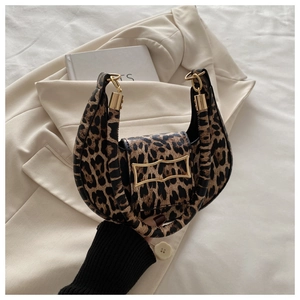Detail of leopard print shoulder bag with gold geometric buckle and stylish curved shape