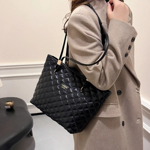 Classic black quilted tote bag with diamond stitching and elegant shoulder straps