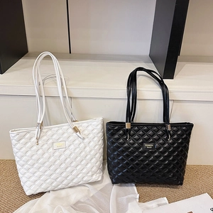 Minimalist diamond quilted leather tote bag set in black and white with fashion tags