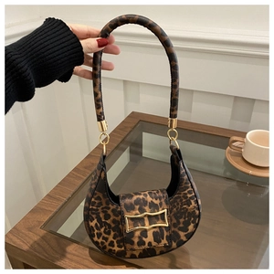 Detail of leopard print hobo bag with a golden bow buckle and round top handle