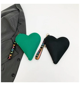 Detail of heart-shaped leather pouches in green and black with LOVE rainbow wristlet strap