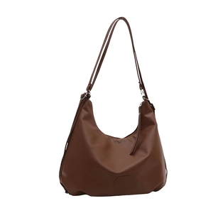 Brown faux leather hobo shoulder bag with adjustable strap and minimalist half-moon design
