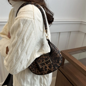 Fashionable leopard print half-moon shoulder bag with a stylish gold buckle detail
