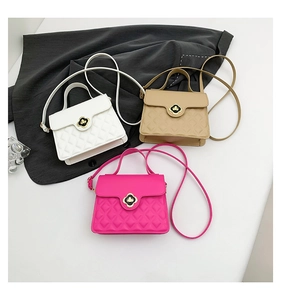 Detailed view of three quilted leather crossbody bags with clover-shaped metal clasps