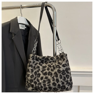 Detail of plush leopard print tote bag with faux fur texture and silver chain strap