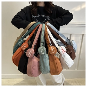 Macro shot showing diverse colors of corduroy crescent bags with textured finish