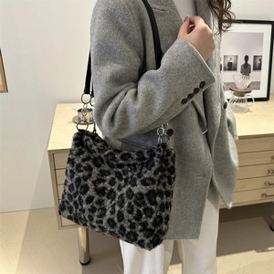 Stylish faux fur leopard print tote bag with black leather strap and silver chain detail
