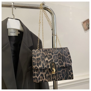 Close-up of vintage leopard print crossbody bag with gold chain and ring buckle