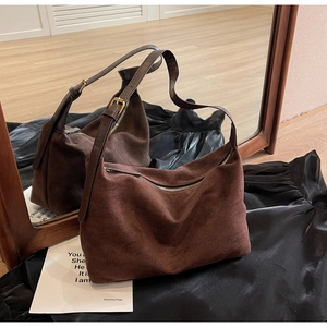 Mirror reflection view of a large brown suede hobo bag with adjustable gold buckle strap