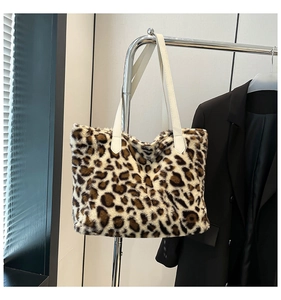 Detail of plush leopard print tote bag featuring ivory faux leather strap and soft faux fur texture