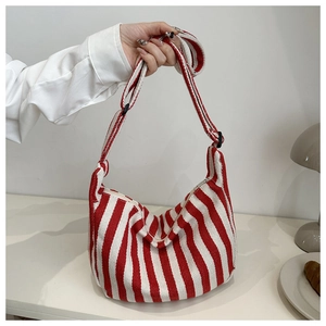 Detail of red and white striped canvas hobo bag with adjustable strap and zipper closure