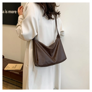 Detail of soft dark brown hobo tote bag shown worn over the shoulder for a commuter style
