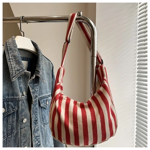 Close-up of red and white striped canvas hobo bag with adjustable wide shoulder strap