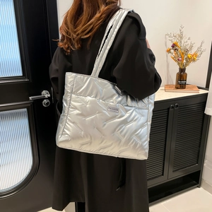 Quilted silver puffer tote bag with large capacity and shiny metallic finish