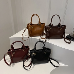 Chic leather bucket bags in various colors with twin handles and fashion embossing
