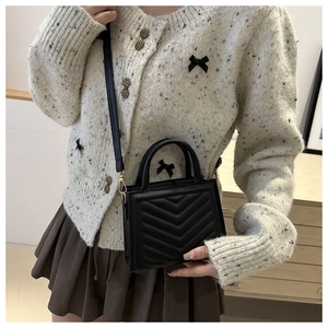 Classic black V-quilted structured handbag with dual handles and gold metal hardware