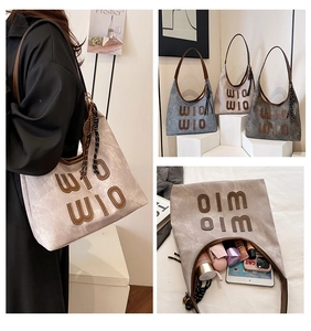 Detail view of large tote bag interior capacity showing tablet and makeup essentials