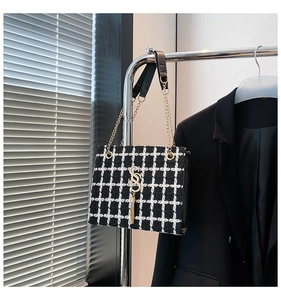 Detail of tweed checkered tote bag with gold SS logo and elegant chain strap
