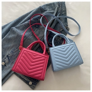 Detailed V-quilted texture on stylish crossbody handbags in fuchsia and pale blue colors