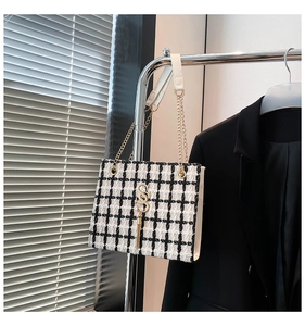 Detail of tweed checkered tote with gold SS logo, tassel, and chain strap for women