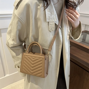 Quilted khaki leather crossbody bag with V-shaped stitching and golden hardware