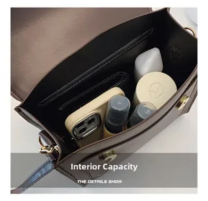 Interior view of the dark brown PU leather shoulder bag showing large storage capacity