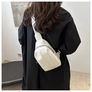 Rear view of a white minimalist PU leather crossbody chest bag on a female model