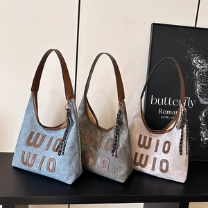 Vintage letter tote bags in blue, grey, and cream colors with tassel and brown handles