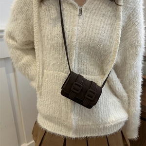 Brown crocodile embossed mini crossbody bag worn with white hoodie and khaki skirt