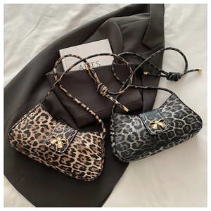 Detail of leopard print shoulder bags with gold bow metal buckles in two stylish colors