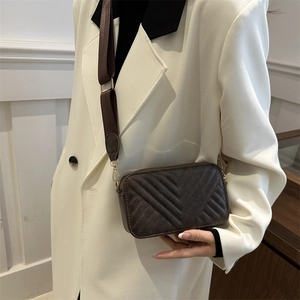 Deep brown quilted crossbody bag with stylish wide shoulder strap for women