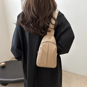Minimalist beige crossbody chest bag for women with wide fabric strap and top zipper