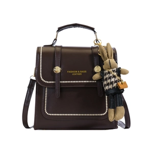 Dark brown vintage faux leather handbag with rabbit pendant and white stitching details